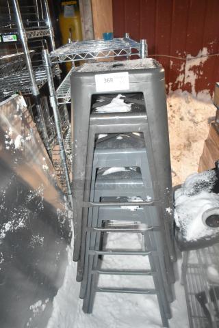 5 gray metal Tolix style stools, stacked, snowy condition, auction label "368". Durable industrial design.