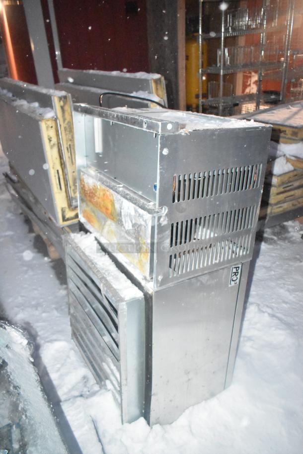 Self-contained walk-in box with PTN047M6BE 208-230V compressor, 1 phase; stainless steel exterior with visible rust and snow.