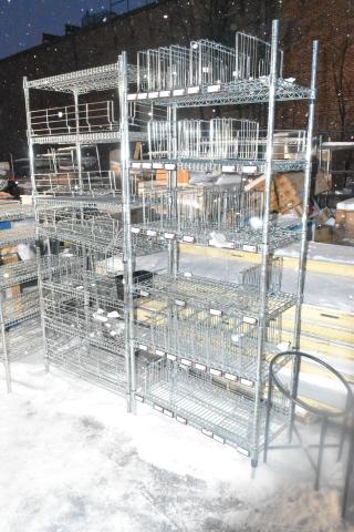 Two chrome wire shelving units outdoors, snow-covered. Six-tier storage with grid baskets. Buyer dismantles; consider freight.