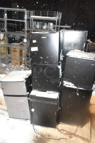 Ten various mini coolers, including Arctic King, Haier, Galanz models; 115 volts, 1 phase. Snow-covered, with visible brand labels.