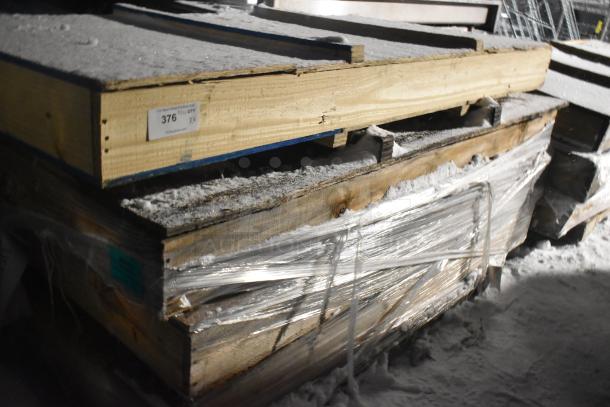 Crates of brand new items wrapped in plastic, labeled "376 in qty x4", indicating four units per bid.