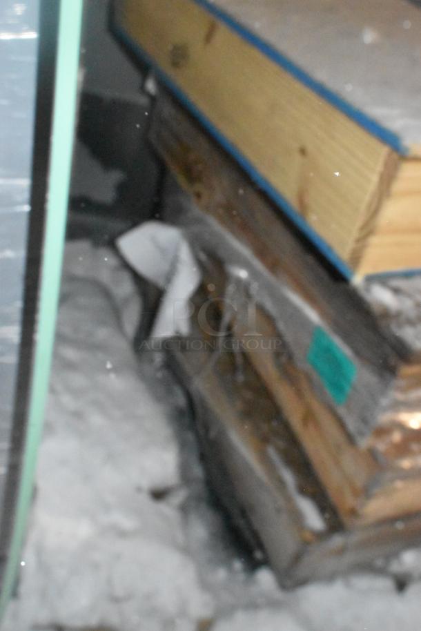 Crate containing four brand new items, unopened. Features wood construction and visible packing materials.