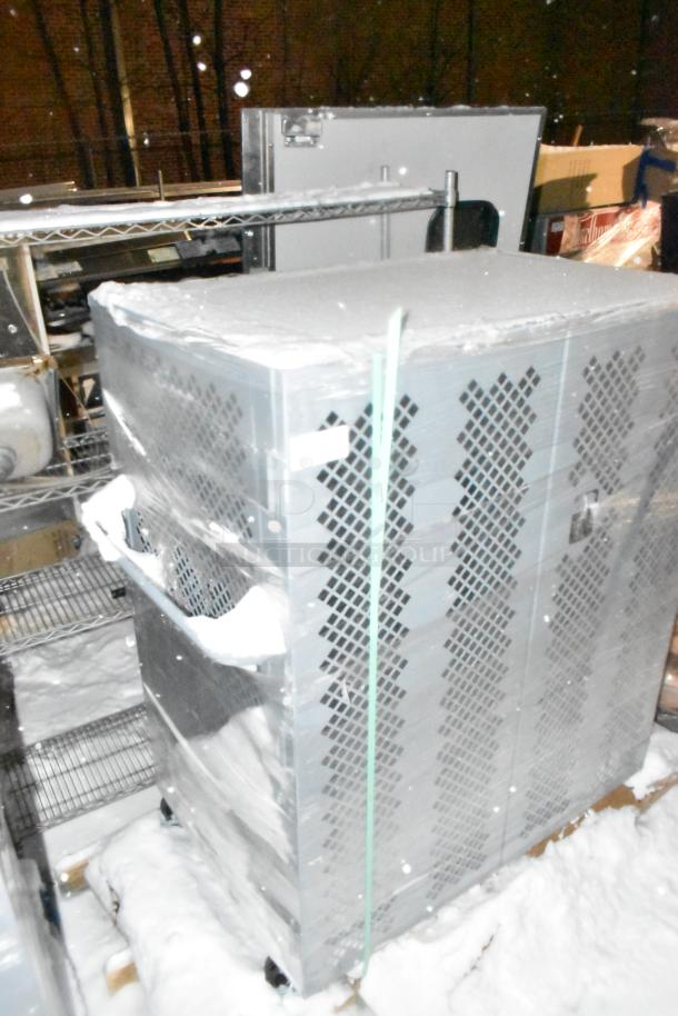 Winholt gray metal cage on pallet, wrapped, vented design, sturdy construction, shows light snow, ideal for storage and transport.