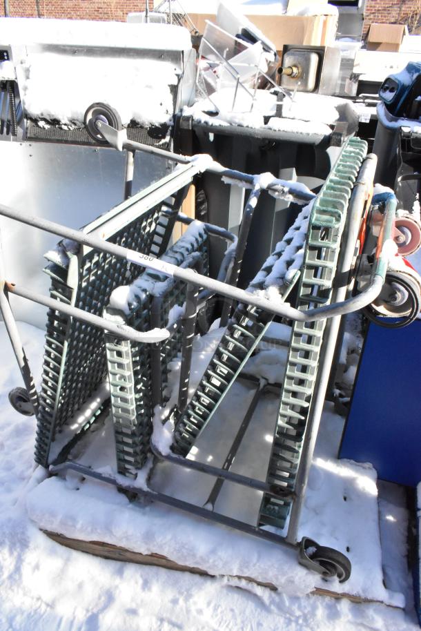 Chrome finish cart with commercial casters, sturdy metal frame, used condition, minor snow cover, ideal for heavy-duty use.