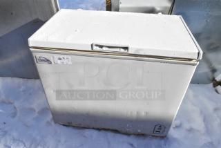 Yukon YCF7 metal chest freezer, 115 volts, 1 phase. Visible Yukon label and auction tag. Appears in used condition.