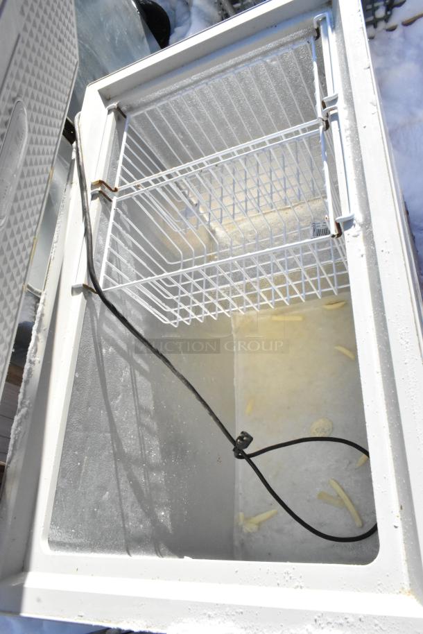 Yukon YCF7 metal chest freezer, 115 volts, excellent condition, features a spacious interior with a wire basket.