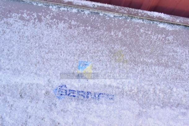 Berner Metal Unit covered in frost, featuring Berner logo. Condition appears weathered, indicating potential outdoor usage.