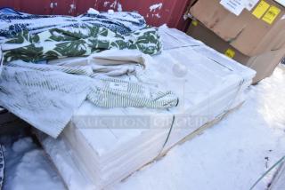 Pallet lot of various items, including folded patio umbrellas with snow covering, visible item label marked "385".