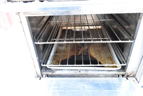 Radiance stainless steel commercial oven interior with racks and residual stains, indicating heavy use; part of 10 burner range.