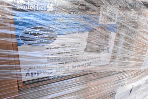 A wrapped pallet showing packaged items with visible labels. Items include Stolzle Bordeaux Glasses and beverage carafes. Scratches and dents possible.