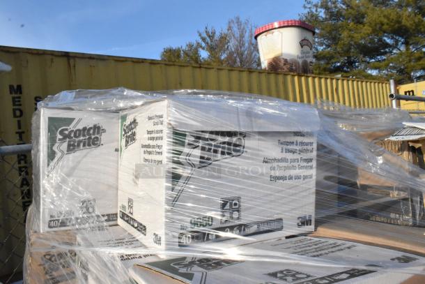 Boxes of Scot Brite scrubbing pads wrapped in plastic, ready for auction. Scratch and dent items included.
