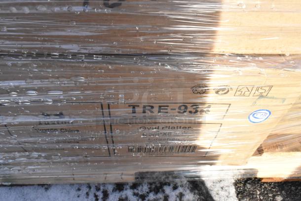 Packaging of Tuxton TRE-934 Oval Platters with visible labels, wrapped in plastic. Part of a scratch and dent auction lot.