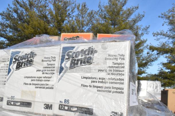 Plastic-wrapped boxes of Scotch Brite Heavy Duty Scouring Pads, labeled No. 86, 12 pads per box, displayed outside.