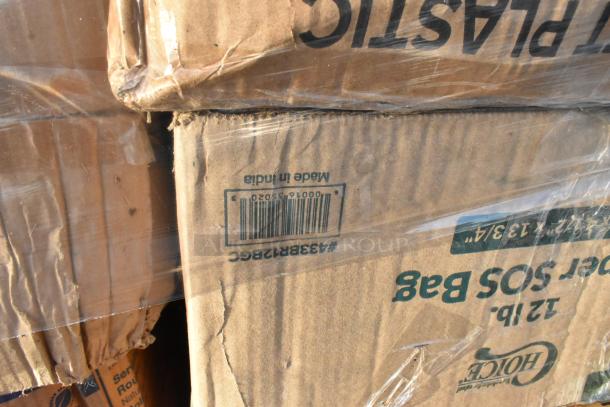 Stacked boxes labeled "Made in India" and "12 lb." with visible scratches and dents. Packaging shows item codes.