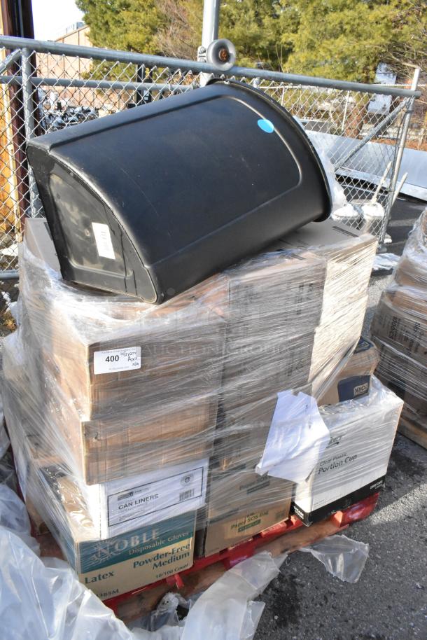 Pallet of 29 new scratch and dent items including strip curtains, tabletop, trash can, and boxes of can liners.