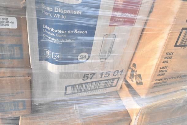 Pallet of mixed new items including soap dispensers, marked with product codes, packaged in shrink wrap.