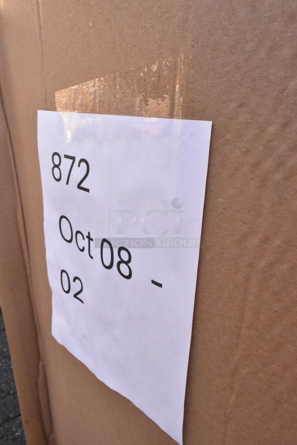 Cardboard box with label "872 Oct 08-02," containing 20 new scratch and dent items like take-out containers and hot cups.