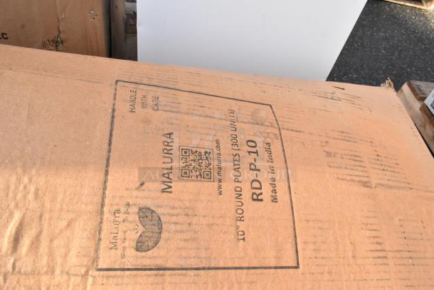 Cardboard box labeled "Malurra RD-P-10," containing 10" round plates, 300 units, made in India. Box shows minor wear.