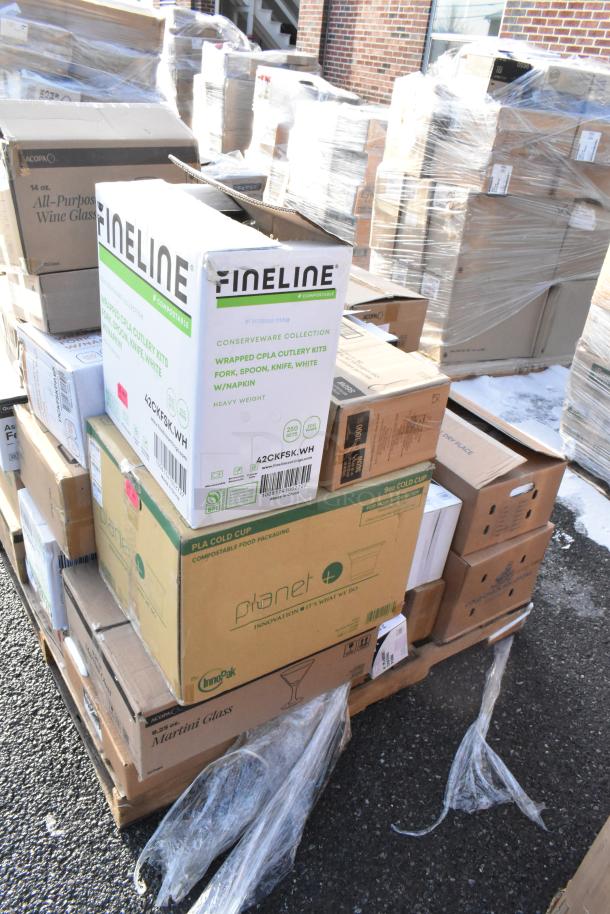 Boxes of various new scratch and dent items, including Fineline cutlery kits, Planet PLA cups, and Acopa glasses, stacked on pallets.