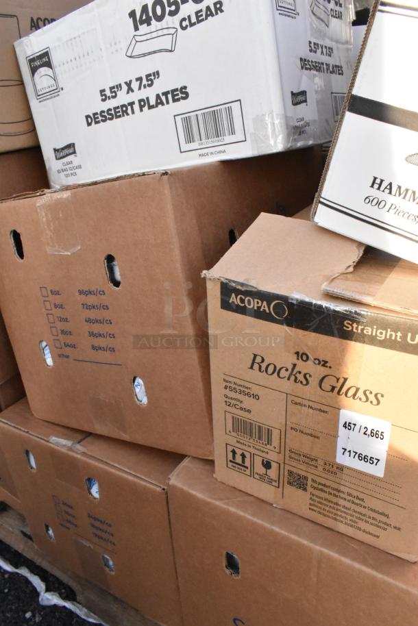 Boxes of various kitchen items including dessert plates and rocks glasses. Some are labeled "scratch and dent."