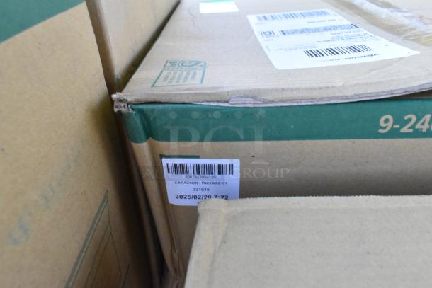 Boxes of new scratch and dent items including cold cups and lids. Barcodes and labels visible with some corner wear.