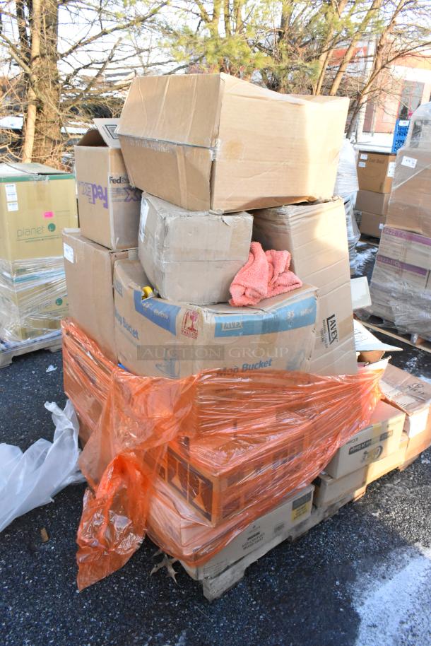 Stack of boxes on a pallet, wrapped in orange plastic. Includes items like plates, a trash can, and a condiment caddy.