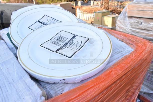 Stack of new dinner plates with labels, indicating size and brand, on a wrapped pallet.