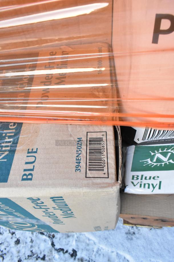 Boxes of blue nitrile gloves and blue vinyl items, wrapped in orange plastic. Barcode: 000111088500. 38 items total.