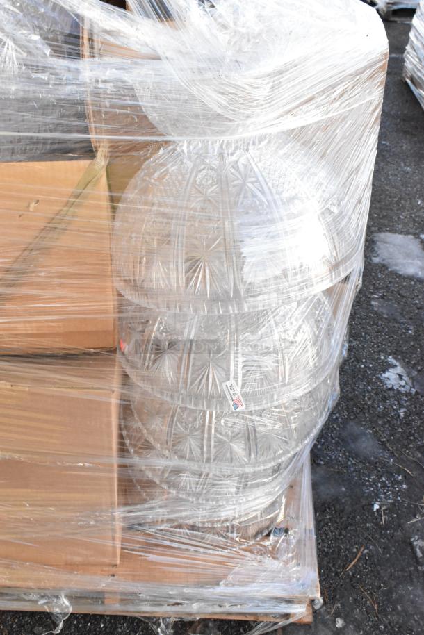 16 brand new scratch and dent clear punch bowls wrapped on a pallet with visible packages, marked "Made in USA."