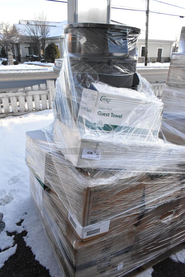 Plastic-wrapped pallet of 14 new items including a trash can and Regency drawer, with visible Choice Guest Towel boxes.