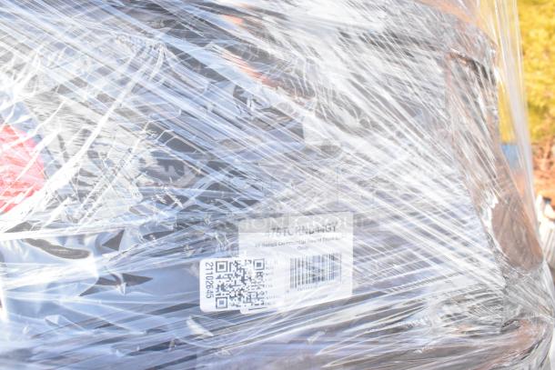 Plastic-wrapped bundle of new scratch and dent items, including a Regency drawer and trash can. Visible label: "44 Gallon Commercial Round Trash Container, Gray."