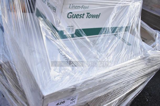 Shrink-wrapped pallet of assorted items, including linen-feel guest towels, marked "Qty x14," labeled "Medifirst."