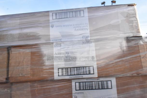 Plastic-wrapped pallet with 52 Tork towel adapters for interfold and multifold towels, new scratch and dent items.