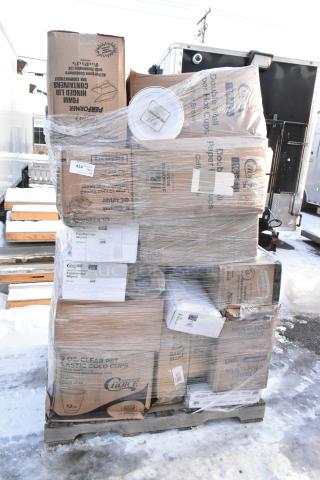 Stack of 26 brand new scratch and dent items, including napkins, cone cups, plates, and cold cups, wrapped on a pallet.