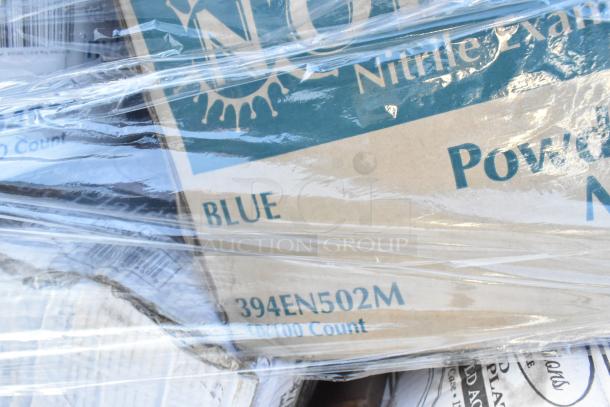Boxes of nitrile gloves labeled "Powder-Free," "Blue," and "394EN502M," wrapped in plastic, part of auction lot.