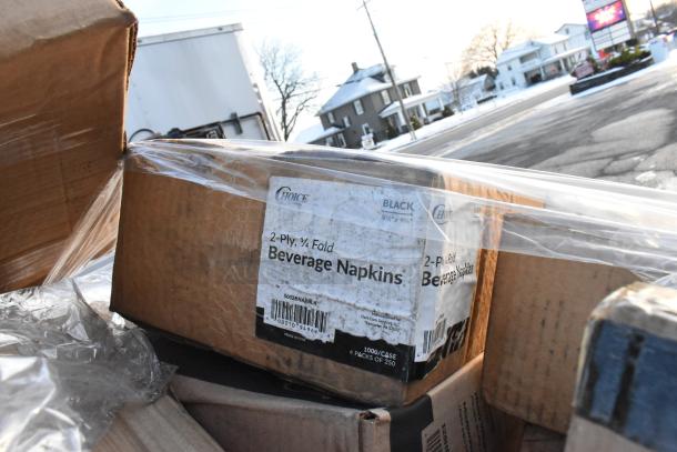 Boxes of 2-ply, 1/4 fold black beverage napkins by Choice, seen wrapped in plastic, with visible label details.
