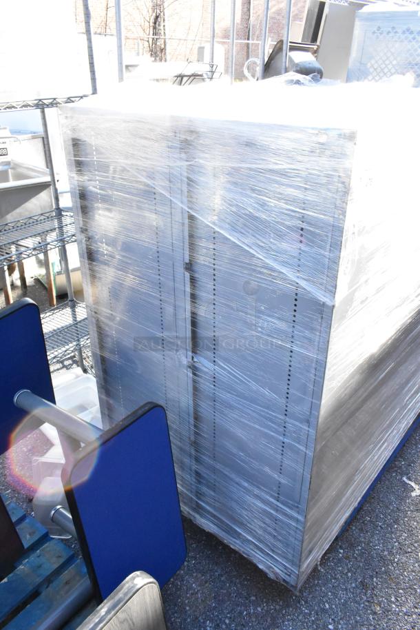 Two gray metal units, shrink-wrapped, in good condition. Auction offers double bid value.