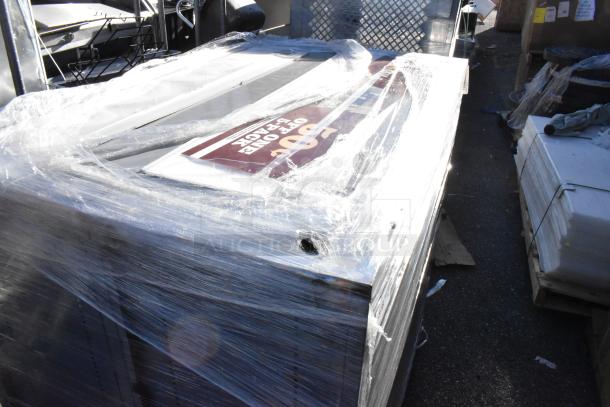 Two gray metal units wrapped in plastic, showing a slight gloss. Visible label indicates "2 Times Your Bid!" Condition appears good.