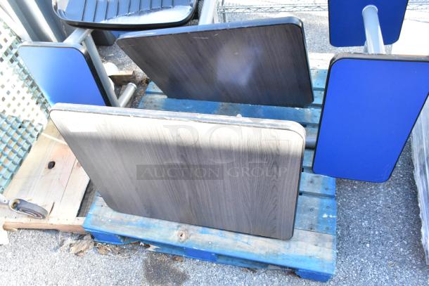 Two booth setups with wooden tabletops and blue side panels, includes two benches; good condition.