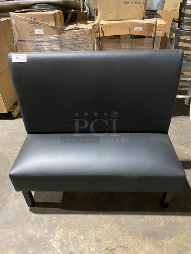 Brand new black upholstered commercial restaurant booth on legs; pristine condition; tag displays item number 50.