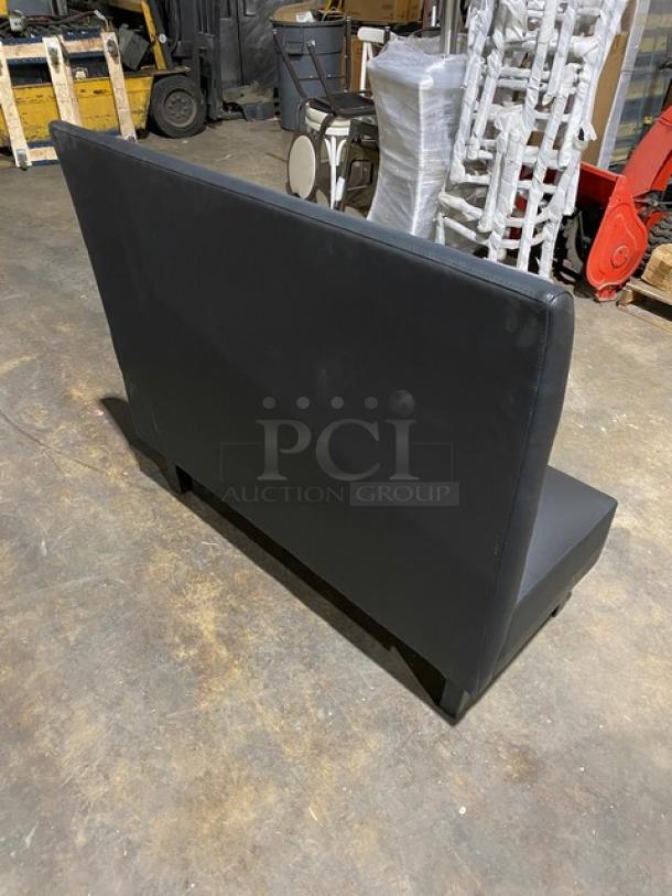 Alt text: Brand new commercial black upholstered restaurant booth with sturdy legs, sleek design, perfect condition.