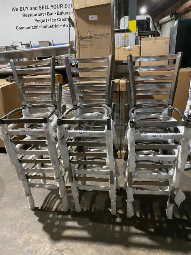 Brand new commercial metal ladder-back stackable dining chair frames, partially wrapped, in warehouse setting.