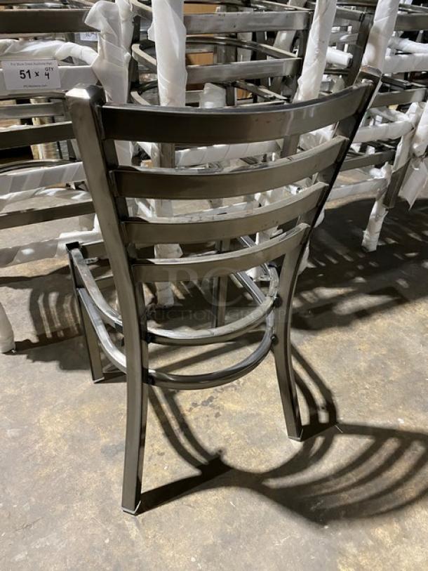 Brand new metal ladder-back stackable dining chair frame, commercial grade, shown in warehouse setting.
