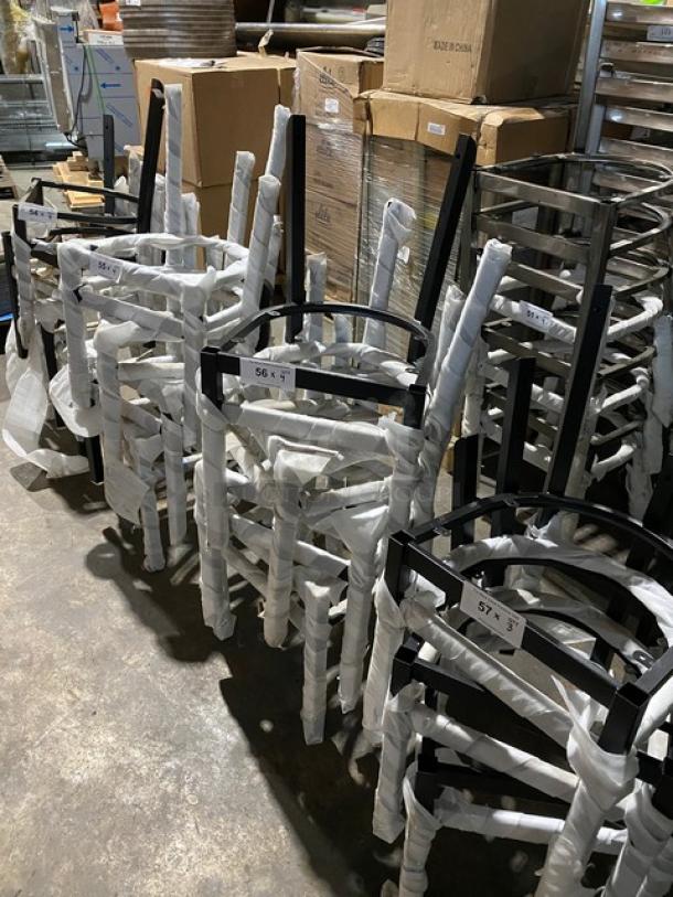 Brand new black steel stackable dining chair frames with curved backrest, wrapped for protection, commercial quality.