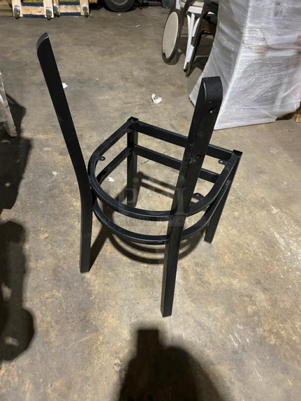 Brand new black steel stackable dining chair frame with curved backrest design, shown in excellent condition.