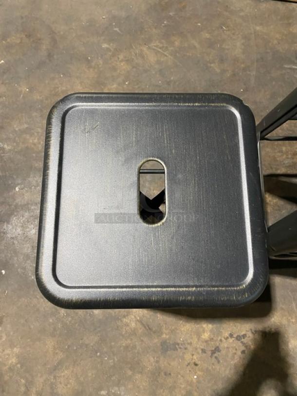 Brand new industrial-style black metal bar stool, backless, stackable, perforated seat, excellent condition.