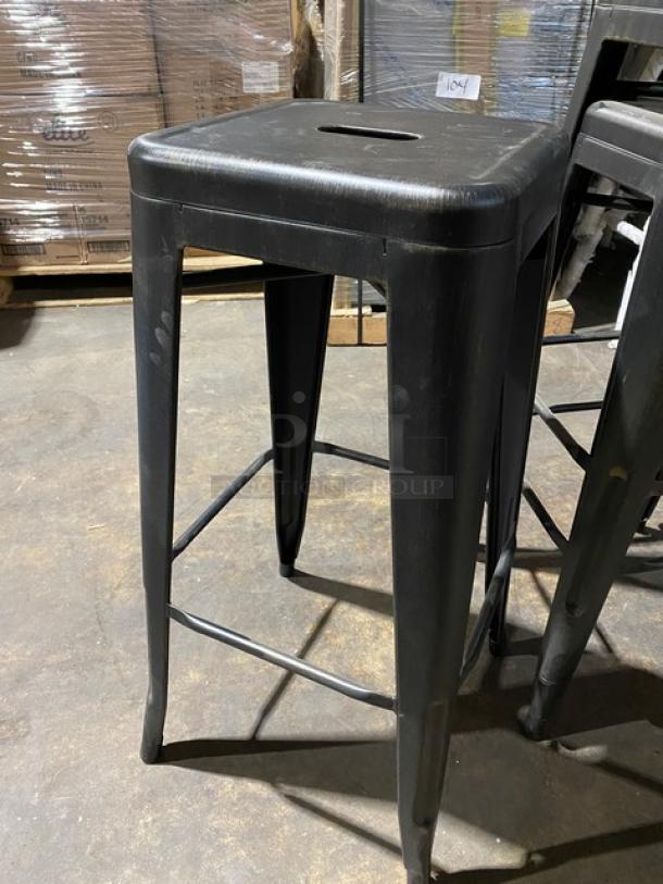 Brand new industrial-style black metal stackable bar stool, backless, commercial grade, in excellent condition.