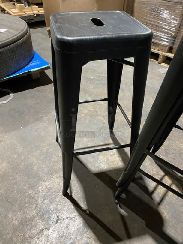 Brand new black metal backless industrial-style stackable bar stool, commercial-grade.