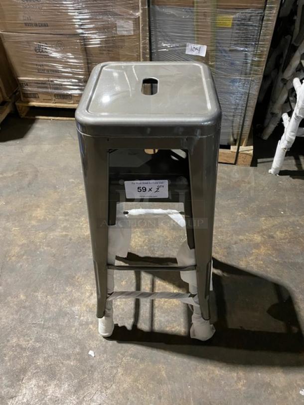 Brand new gunmetal grey industrial-style backless stackable bar stool, durable metal, commercial use, pristine condition.