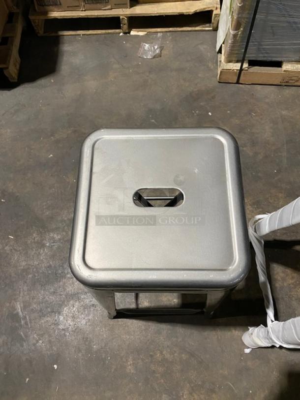 Brand new gunmetal grey industrial-style stackable bar stool; backless design with square seat, ideal for commercial use.